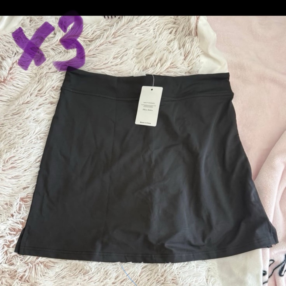 Bundle of four black athletic golf skorts